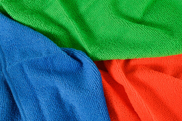 Background of colorful crumpled microfiber cloths.