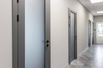 Grey door with glass insert in office building