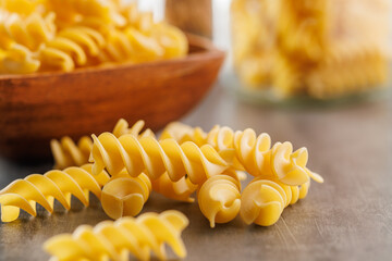 Uncooked fusilli pasta. Uncooked italian pasta on kitchen table.