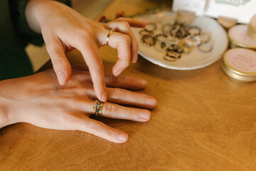 Woman choosing handmade rings in store