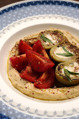 Vegan meal plate with fresh tomatoes, mashed potato and stuffed baked eggplant
