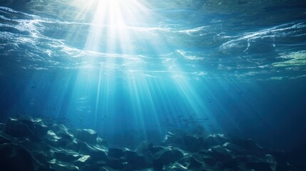 blue gentle waves The ocean surface is visible from underwater rays of sunlight penetrating through...