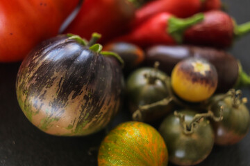 beautiful organic tomatoes of different shades and shapes close-up