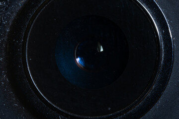 Round lens of a deteriorated mobile phone. Close-up photo of a smartphone camera lens, detaching...