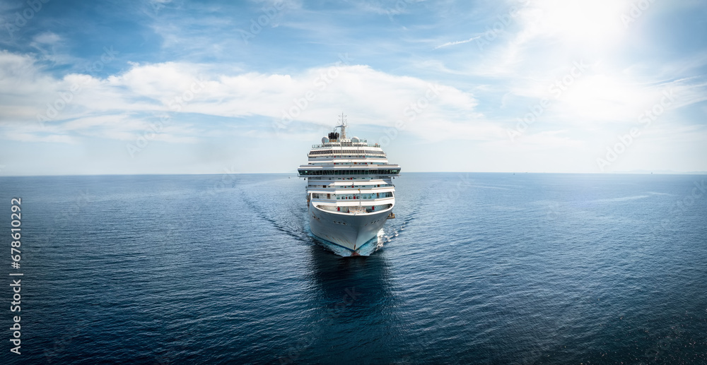 Wall mural front view of a generic cruise ship traveling with speed over calm ocean with copy space