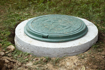 Sewer Manhole on Septic Tank made of Concrete Rings. Construction of Sewerage System, Installing...