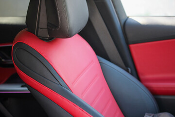 Red and black driver seat of a sporty new vehicle