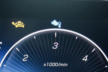 Cold engine icon in the digital gauge cluster of a modern luxury vehicle