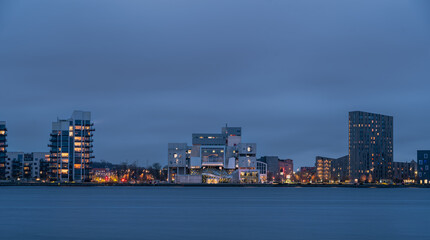 Evening cityscape panorama of the illuminated Aalborg, North Jutland Region (Nordjylland), Denmark. Famous landmark - House of Music (Musikkens Hus) is in the center