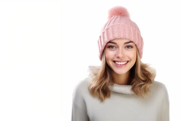 Young smiling woman wearing winter hat standing isolated over white background.