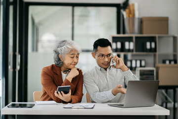 Business team using a calculator to calculate the numbers of statistic business profits growth rate on documents graph data.