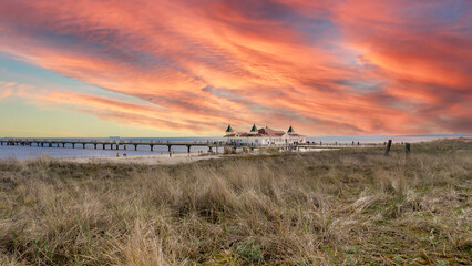 Pier and beach in Ahlbeck on the Baltic Sea on Usedom at sunset - obrazy, fototapety, plakaty