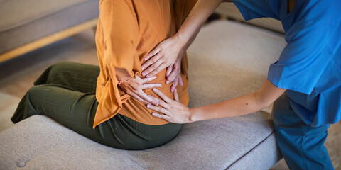 Physical therapist caregiver Asian and Caucasian senior women trust moving hand in rehabilitation