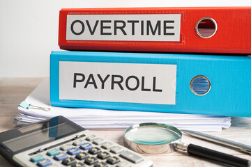Overtime Payroll. Binder data finance report business with graph analysis in office.