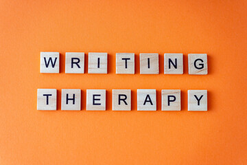 Word writing therapy. The phrase is laid out in wooden letters top view. Motivation. Orange flat...