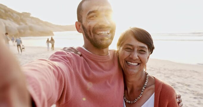 Man, senior mom and beach selfie with hug, care and bonding in summer sunshine for vacation in Mexico. Mature mother, son and happy family holiday with photography for memory by ocean, sand and face