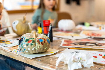 Children's painting class. Painting day with parents in class painting pumpkins.