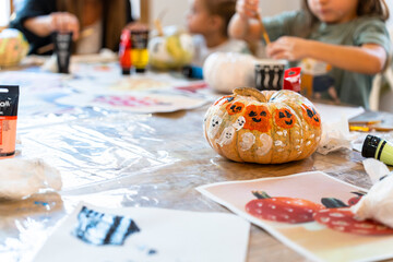 Children's painting class. Painting day with parents in class painting pumpkins.