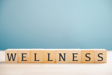 Wellness is highlighted by the word wellness on a wooden cube block, representing mental health, relaxation, and overall well-being. Encourages a healthy, stress-free lifestyle. wellness concept
