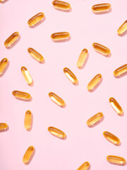 Flat lay Omega 3 golden translucent pills on flat background