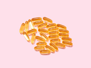 Flat lay Omega 3 golden translucent pills on flat background
