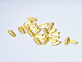 Flat lay Omega 3 golden translucent pills on flat background