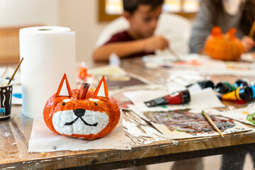 Children's painting class. Painting day with parents in class painting pumpkins.