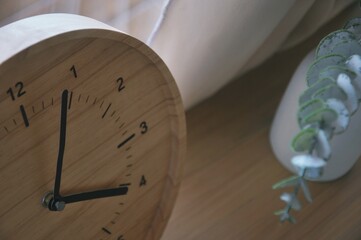 Clock display on wooden table background , wooden clock interior decoration in bedroom