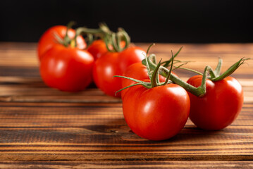 Tomatoes, beautiful bunch of tomatoes in detail on rustic wood, selective focus.