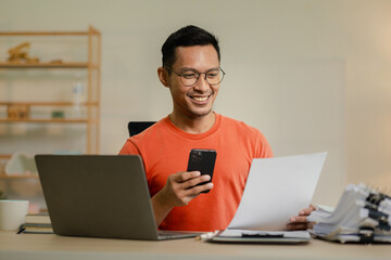 Businessman is working in the office and talking on the phone with a partner, Entrepreneurs use smartphones to find information in order to present it, Working in a private office at a company.
