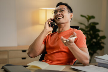 Businessman is working in the office and talking on the phone with a partner, Entrepreneurs use smartphones to find information in order to present it, Working in a private office at a company.