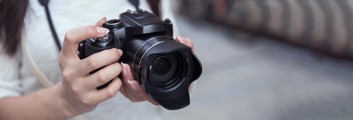 woman holding camera in street
