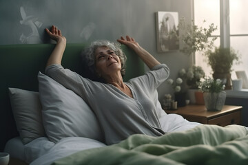 Fresh senior woman stretching in bed, waking up alone. Senior lady awake after healthy sleep, sitting in cozy comfortable bedroom enjoying good morning. - Powered by Adobe