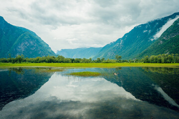 Cape Kyrsai on Lake Teletskoye in the Altai Mountains. Summer landscape in the mountains near a...