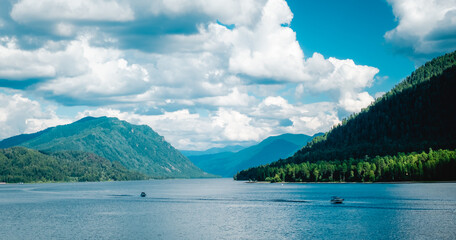 Aerial view of Teletskoye lake in the Altai Mountains in summer. Coniferous forest, blue sky with...