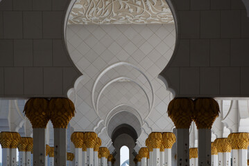Arch and columns of the Sheikh Zayed Grand Mosque in the courtyard. Abu Dhabi, UAE - 8 February,...