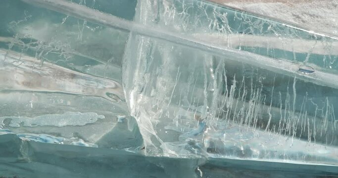 close-up of polished transparent ice blocks with frozen air bubbles in masonry, abstract background