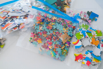 Fototapeta na wymiar Organization of space and storage of children's board games. Storing puzzles in zip bags.
