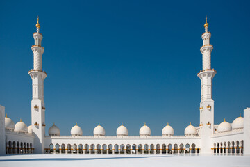Fototapeta na wymiar Minaret towers, domes and the inner courtyard of the Sheikh Zayed Grand Mosque. Abu Dhabi, UAE - 8 February, 2020