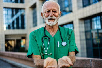 Healthcare open hands and mature man doctor working in a hospital for volunteer, support or charity. Help, stethoscope and Caucasian male medical worker with a giving hand gesture in a medicare clinic - obrazy, fototapety, plakaty
