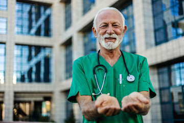 Doctor with stethoscope offering helping hands gesture.