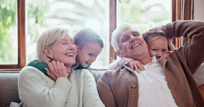 Happy, love and children hugging grandparents on a sofa in the living room at modern home. Smile, bonding and young kids embracing senior man and woman in retirement with care in the lounge of house.