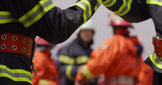 A team of firefighters comes together to celebrate and share their joy and relief after a successful operation, demonstrating the strong bond and camaraderie among these heroic individuals