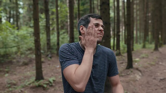 Man repel mosquitoes in the forest