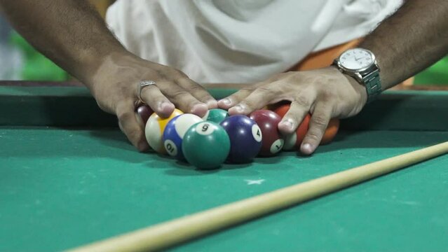 snooker game. close up of hand with cue playing pool on green table