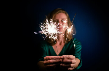 woman holding sparkles Happy New Year