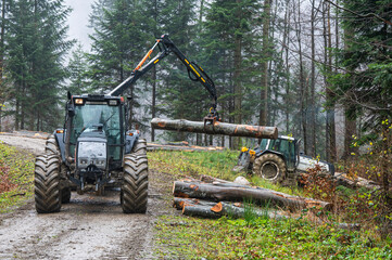 A specialized forest tractor working with logging in the rain in the Carpathians, Poland.