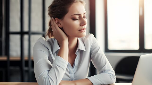 A person experiencing neck pain while working on a laptop at home, illustrating the health risks associated with sedentary office jobs and prolonged computer use.