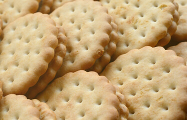 Detailed picture of round sandwich cookies with coconut filling. Background image of a close-up of several treats for tea