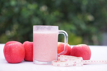 Pink fruits smoothie  in glass, outdoor background. Concept, healthy beverage for health. Well...